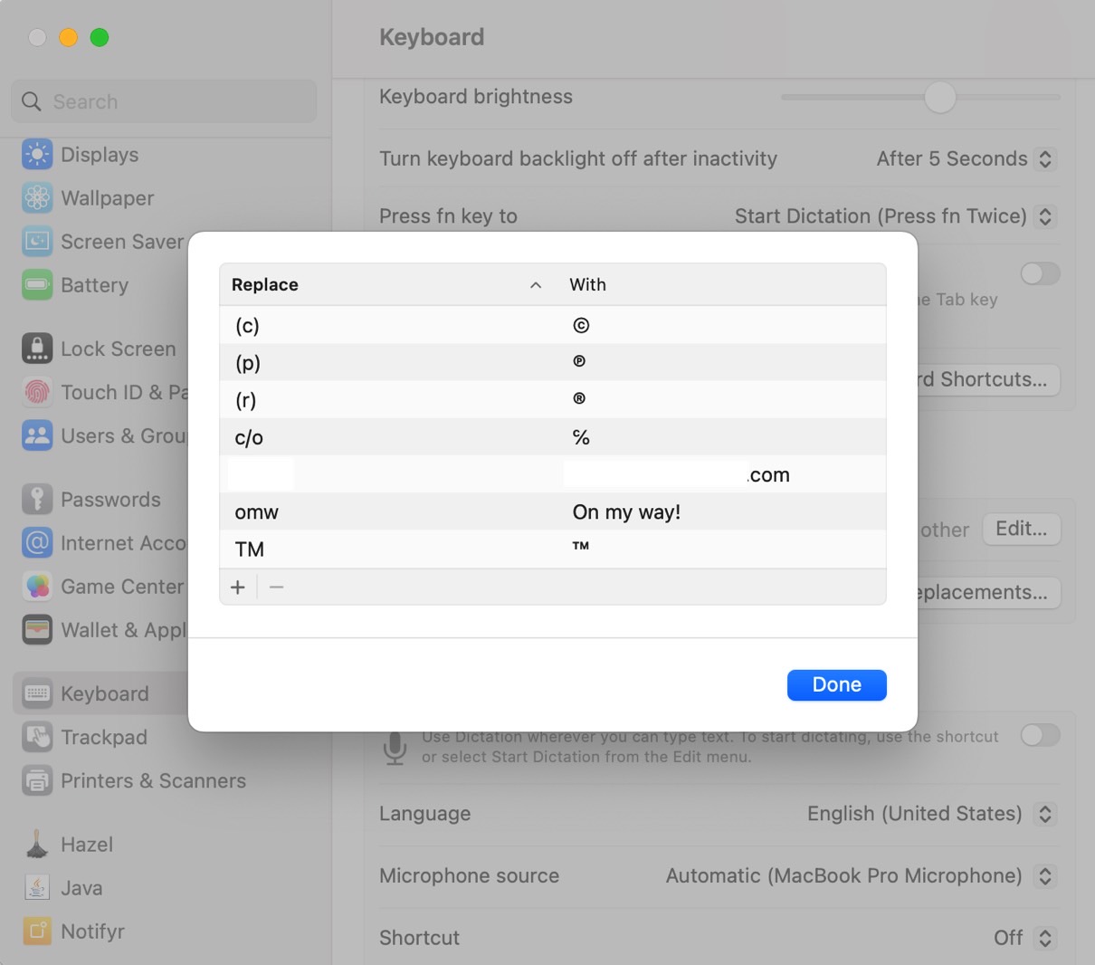 The same list of Text Replacement shortcuts in the Mac's keyboard settings - the redacted