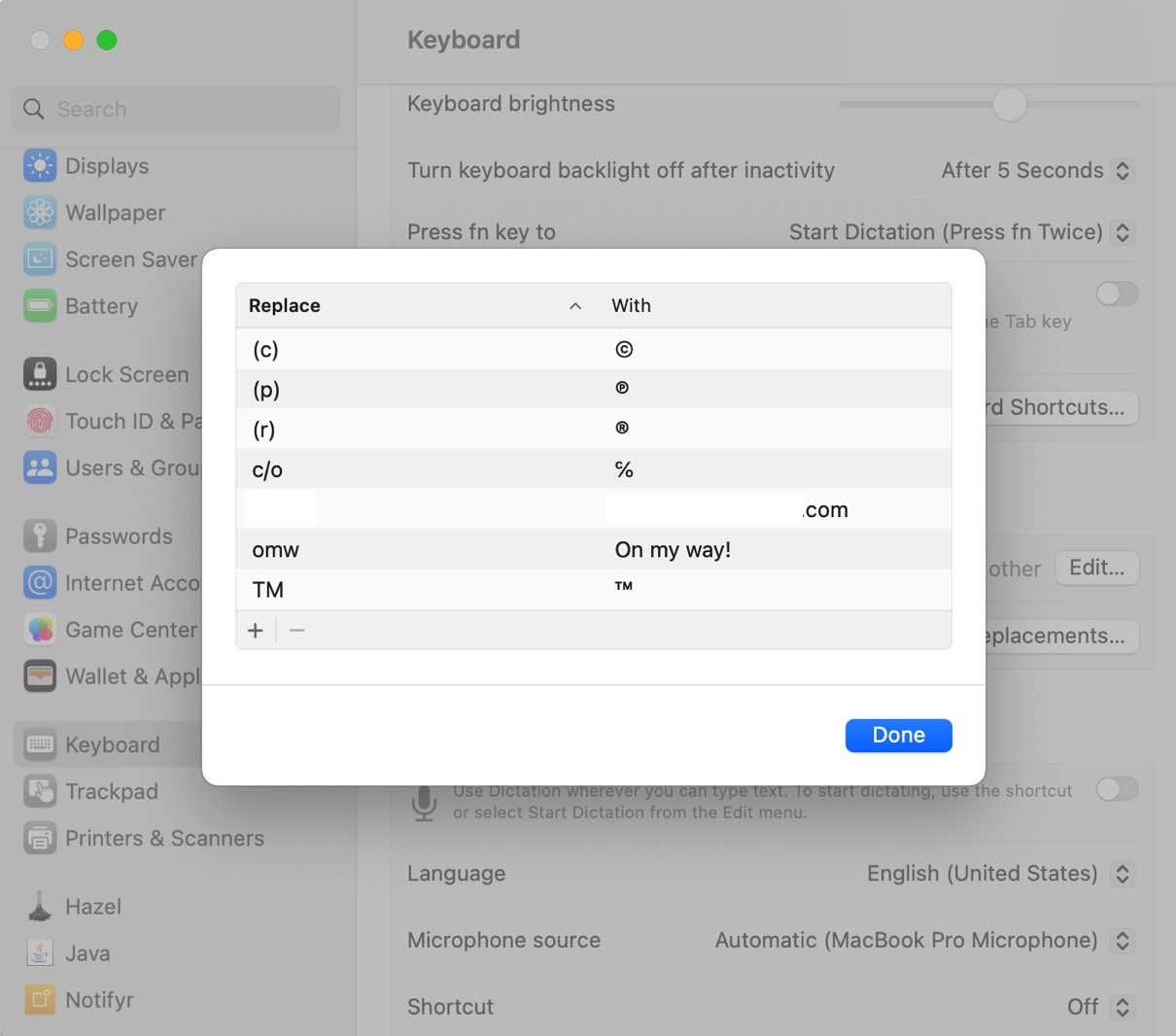 The same list of Text Replacement shortcuts in the Mac's keyboard settings - the redacted 