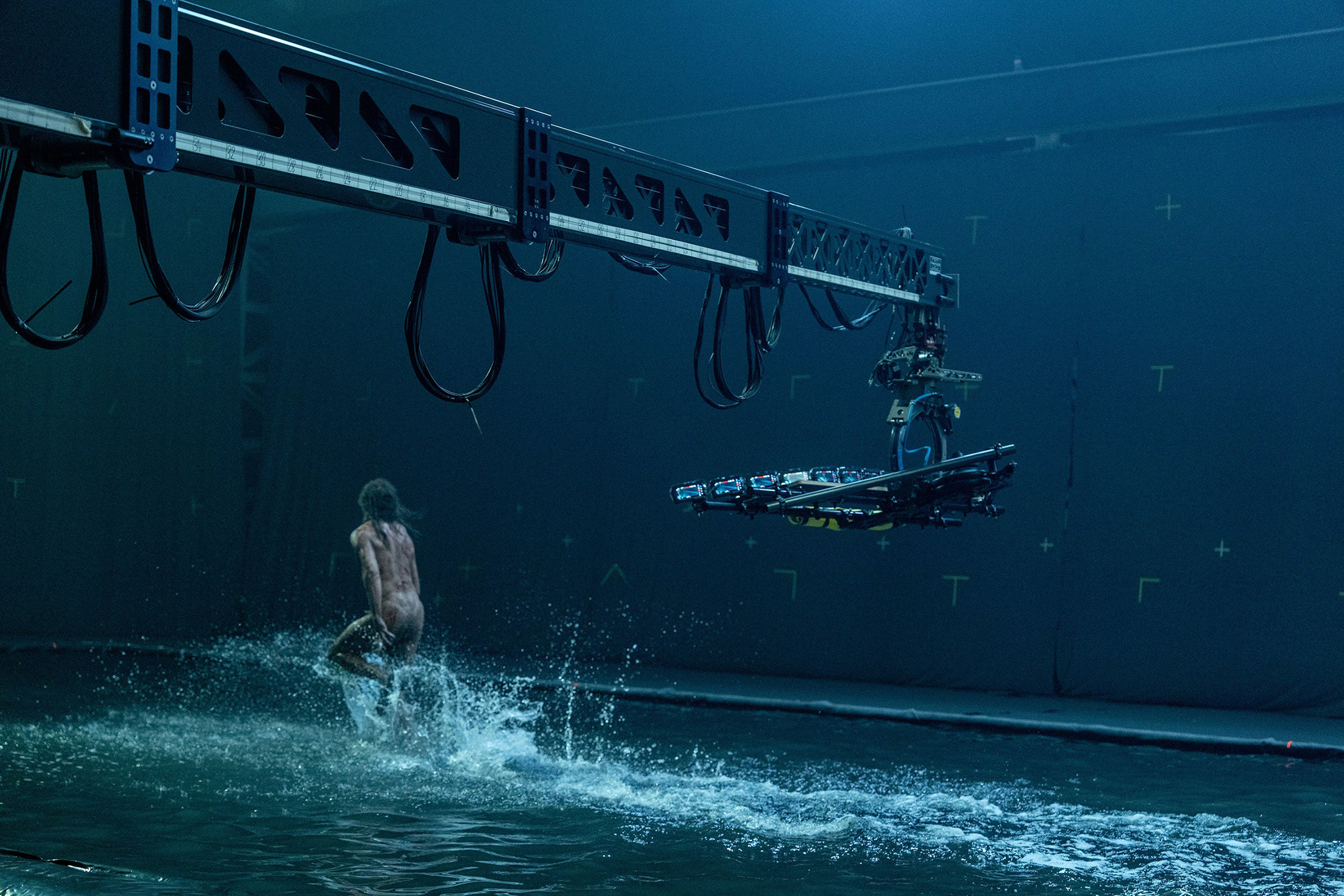 A naked man running through water filmed by a crane-mounted iPhone rig for 28 Years Later.