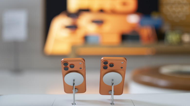 The iPhone 17 Pro models placed on MagSafe stands in a store.