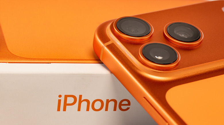 Orange iPhone 17 Pro against an iPhone box
